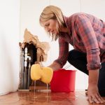 water leak detection at home a woman is mopping a floor (1)