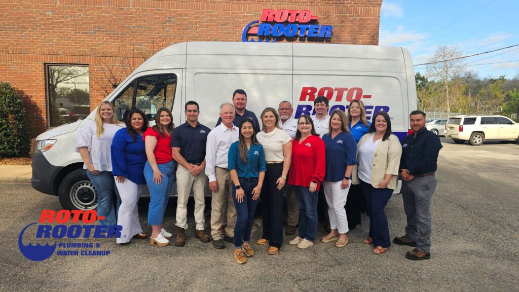 Roto-Rooter Mobile plumbing team standing in front of company van