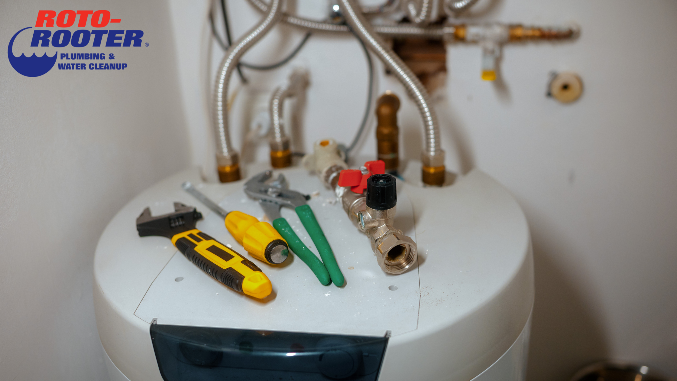 Plumbing tools arranged above a toilet, ready for common home repairs